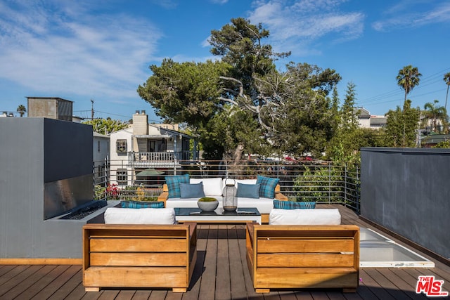 wooden terrace with an outdoor hangout area