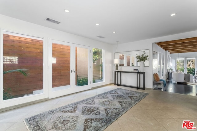 interior space featuring french doors and beam ceiling