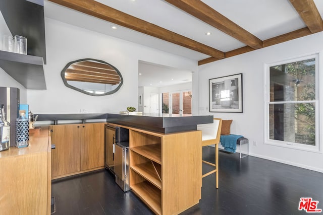 bar featuring beamed ceiling and dark hardwood / wood-style floors