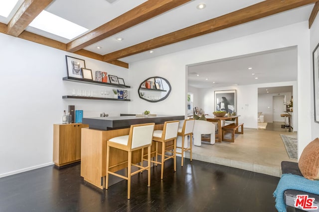 bar featuring beamed ceiling and dark hardwood / wood-style floors