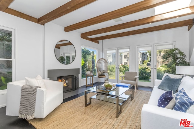 living room featuring beamed ceiling and french doors