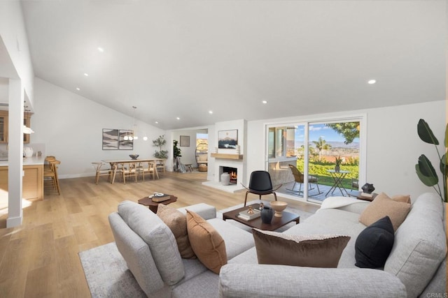 living room featuring light hardwood / wood-style flooring and vaulted ceiling