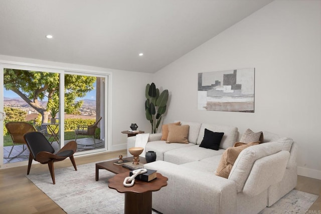 living room with vaulted ceiling and light wood-type flooring