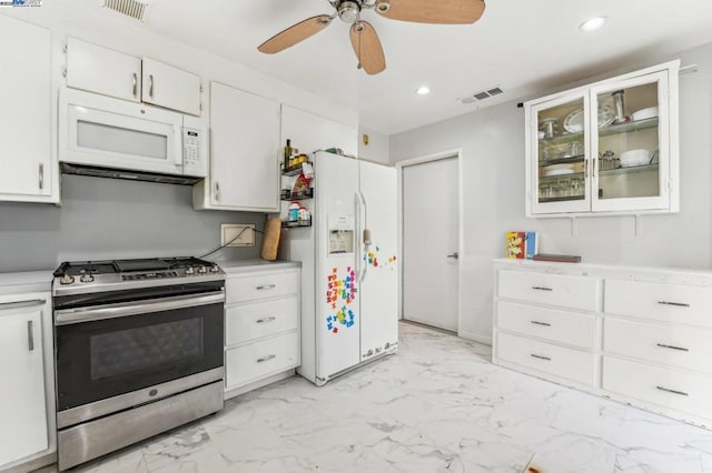 kitchen with white cabinets, ceiling fan, and white appliances