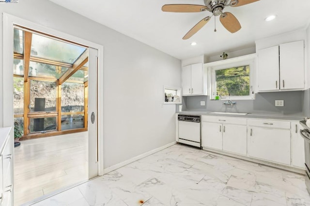 kitchen with white cabinets, white dishwasher, ceiling fan, and sink