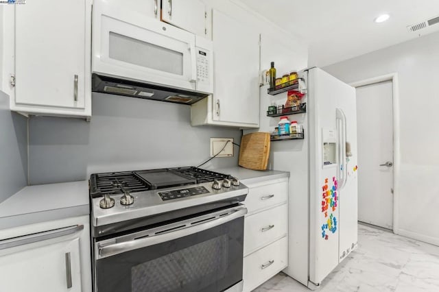 kitchen featuring white cabinetry and white appliances