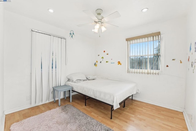 bedroom featuring hardwood / wood-style flooring and ceiling fan