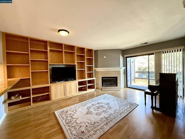 living room with wood-type flooring and a fireplace