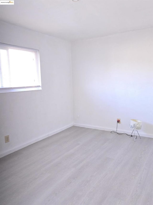 spare room featuring light hardwood / wood-style floors