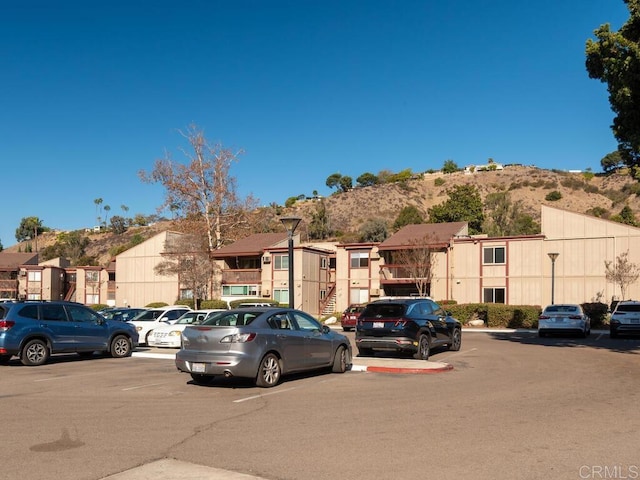 view of parking / parking lot featuring a mountain view