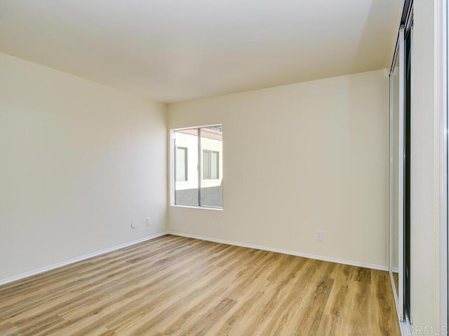 spare room with light hardwood / wood-style flooring