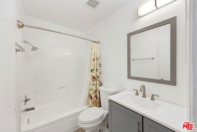 full bathroom with shower / bath combination with curtain, vanity, and toilet