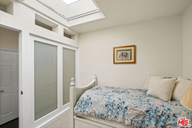 bedroom featuring carpet and a skylight