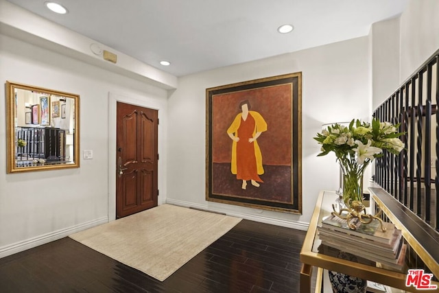 entryway with dark wood-type flooring