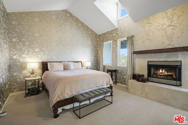 bedroom with carpet floors, a tile fireplace, and high vaulted ceiling