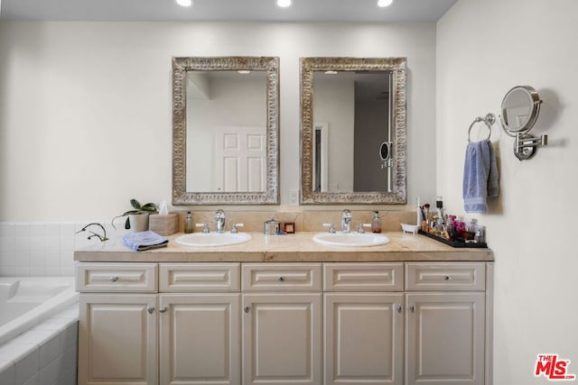 bathroom with a relaxing tiled tub and vanity