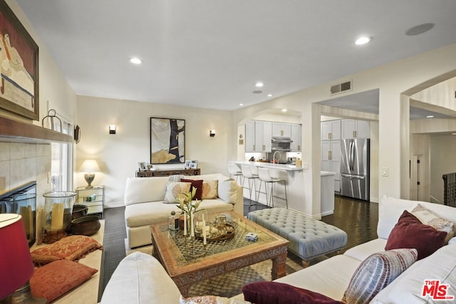 living room with a fireplace and hardwood / wood-style floors