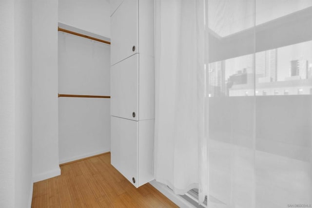 spacious closet featuring light wood-type flooring