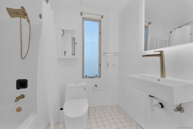 full bathroom with shower / tub combo with curtain, sink, tile patterned floors, and toilet