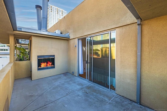 view of patio / terrace featuring an outdoor fireplace