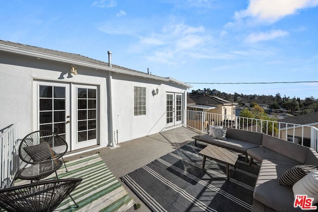 wooden terrace featuring french doors and an outdoor hangout area