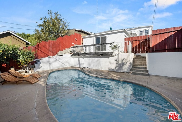 view of swimming pool featuring a patio area