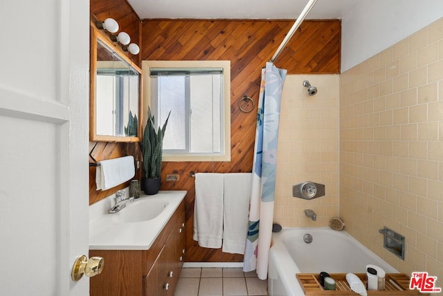 bathroom featuring shower / bath combo, vanity, tile patterned floors, and wooden walls