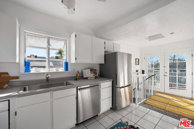 kitchen featuring french doors, sink, light tile patterned floors, white cabinets, and appliances with stainless steel finishes