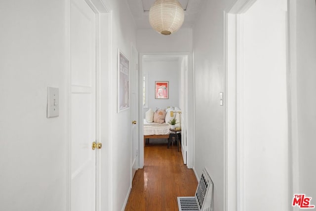 hallway with dark hardwood / wood-style flooring