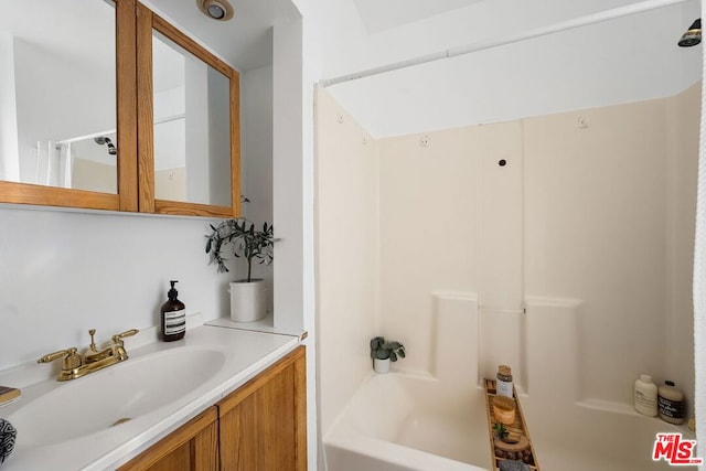 bathroom with shower / bathing tub combination and vanity