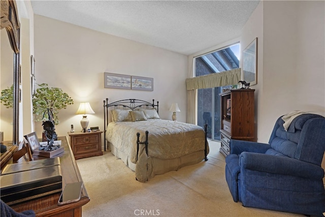 bedroom featuring a textured ceiling and light colored carpet