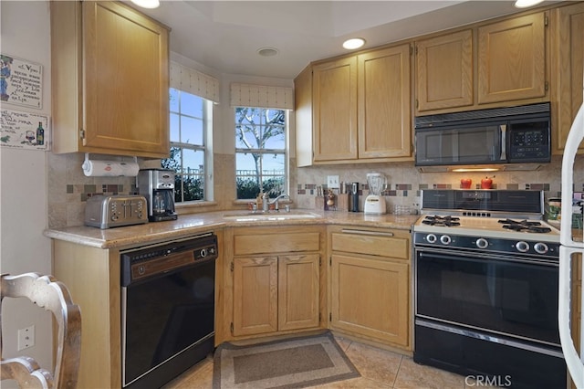 kitchen featuring decorative backsplash, sink, black appliances, and light tile patterned flooring