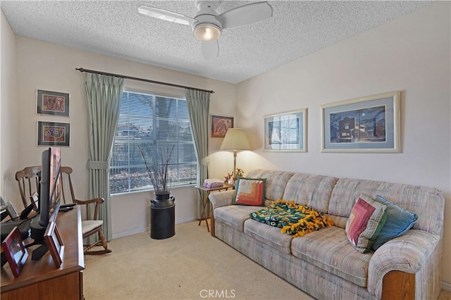 carpeted living room with ceiling fan and a textured ceiling