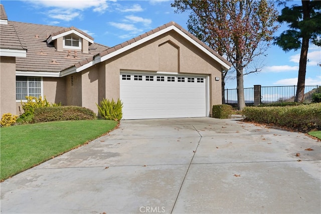 view of front of property featuring a garage and a front lawn