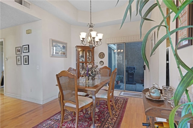 dining area featuring a chandelier and hardwood / wood-style flooring