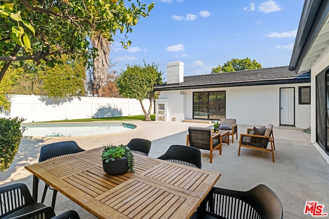 view of patio featuring outdoor lounge area and a fenced in pool