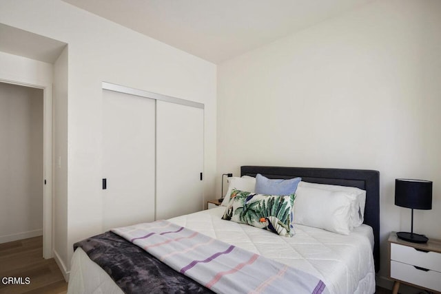 bedroom with hardwood / wood-style floors and a closet