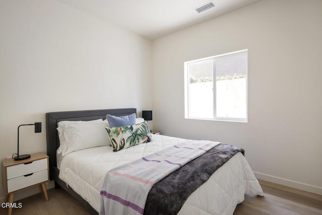 bedroom with wood-type flooring