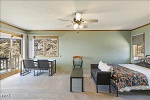 bedroom featuring ceiling fan, crown molding, and light carpet