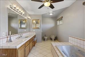 bathroom featuring tile patterned floors, vanity, ceiling fan, a relaxing tiled tub, and a bidet