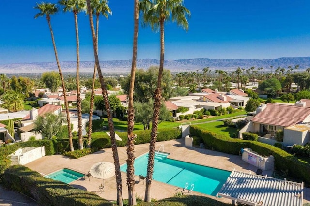 view of pool with a mountain view and a patio