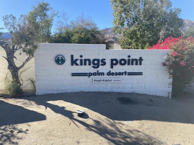 community sign with a mountain view