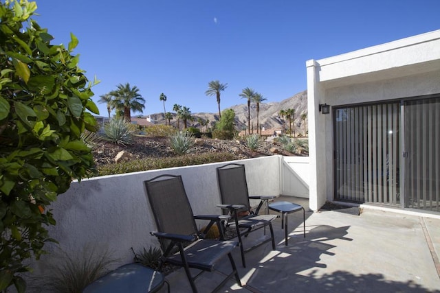 view of patio / terrace featuring a mountain view