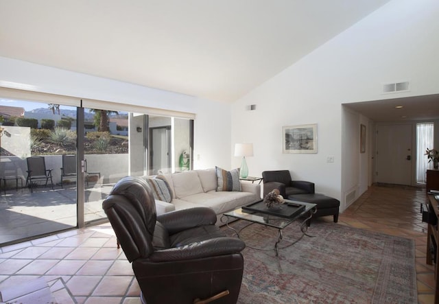 tiled living room with high vaulted ceiling