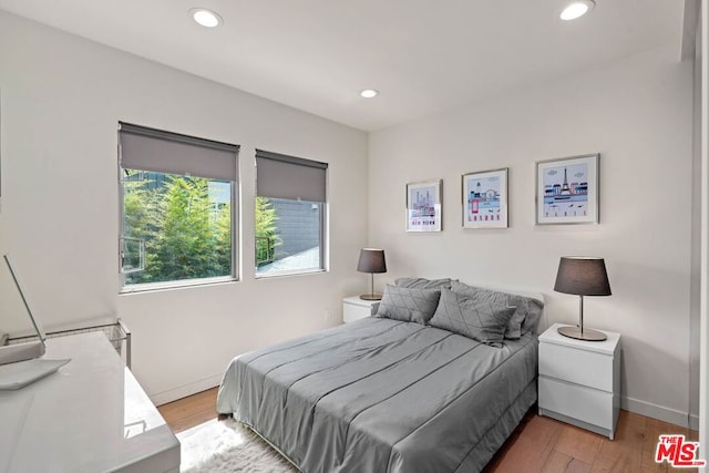 bedroom with hardwood / wood-style floors