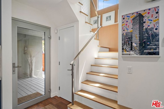 staircase with hardwood / wood-style floors and plenty of natural light