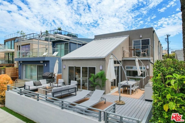 back of property featuring an outdoor living space and a balcony