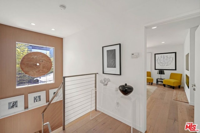 hallway with light hardwood / wood-style floors