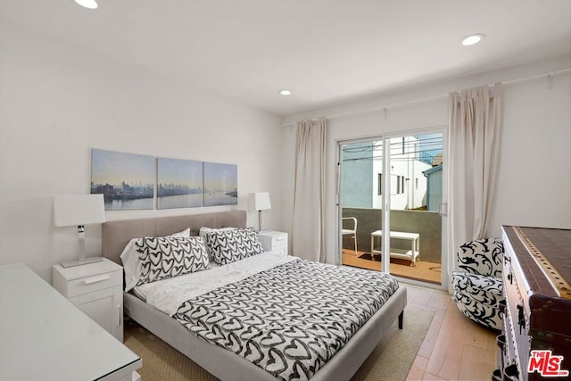 bedroom with access to exterior and light hardwood / wood-style floors