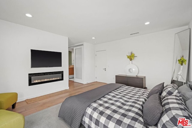 bedroom with light hardwood / wood-style flooring